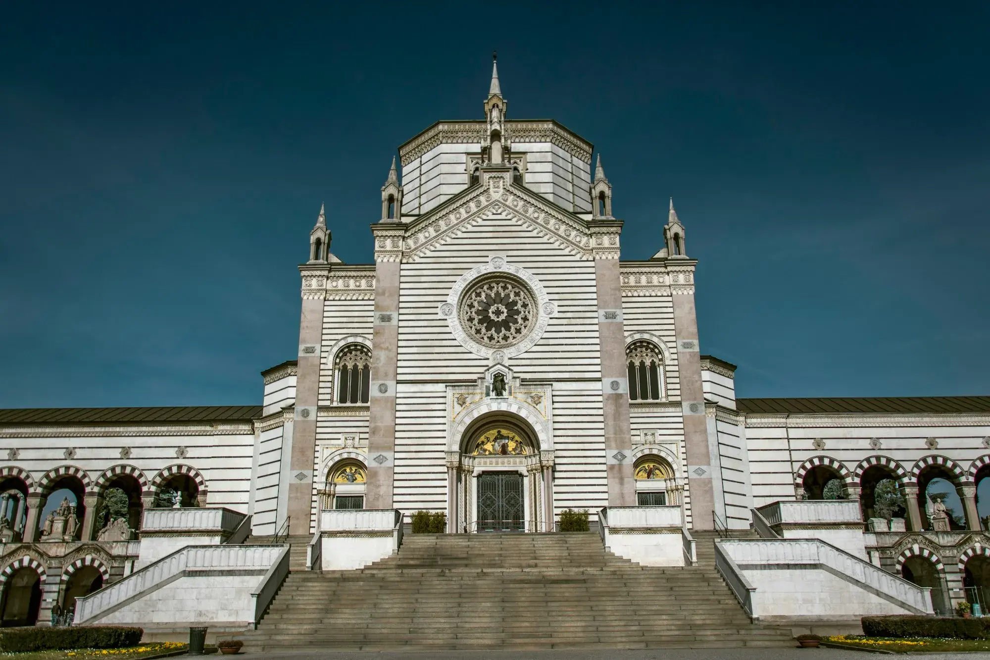 The striped marble Famedio building at the entrance of Milan's Monumental Cemetery