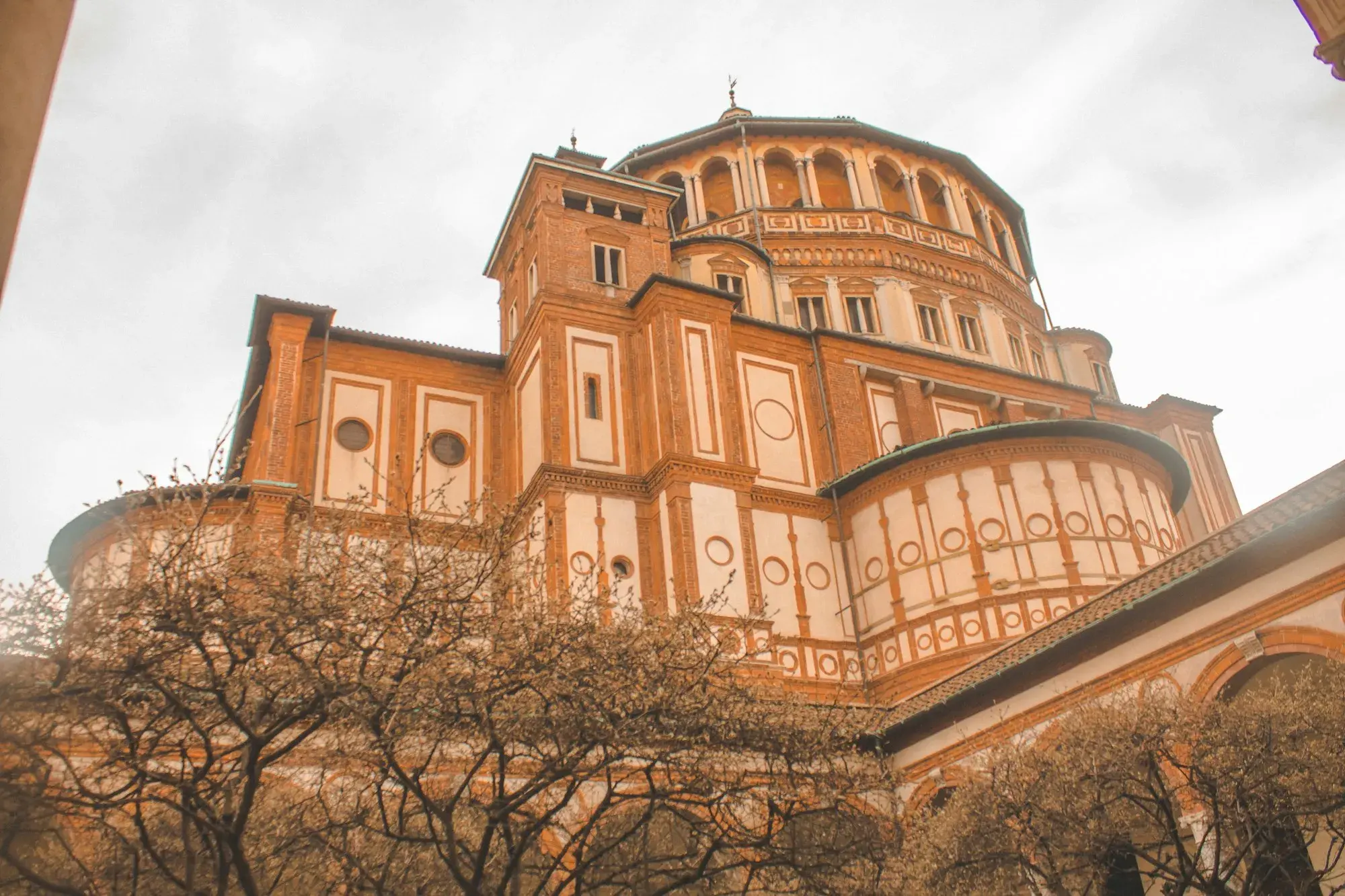 The brick exterior and domed tribune of Santa Maria delle Grazie in Milan