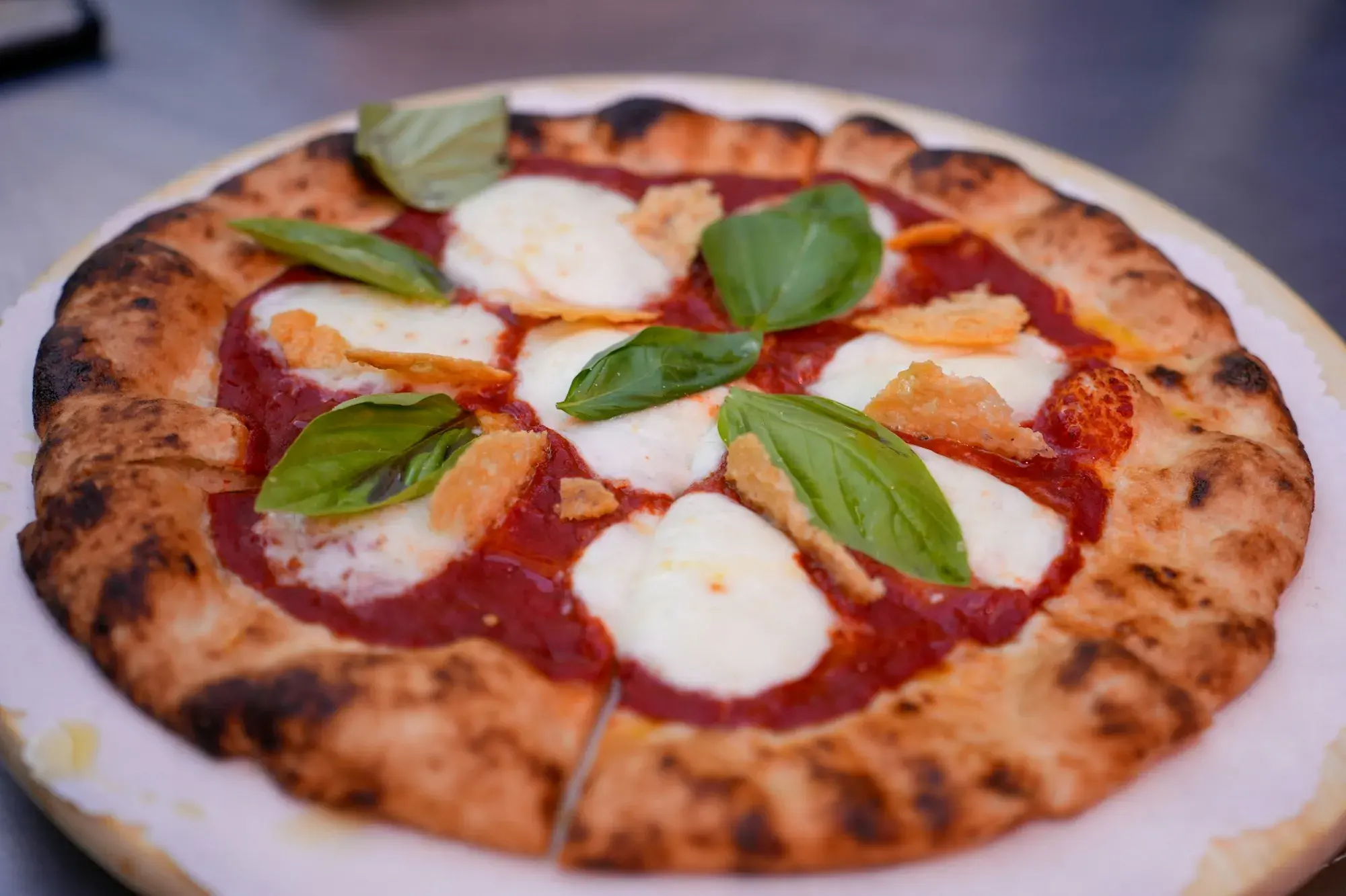 A Margherita pizza with tomato, mozzarella and fresh basil