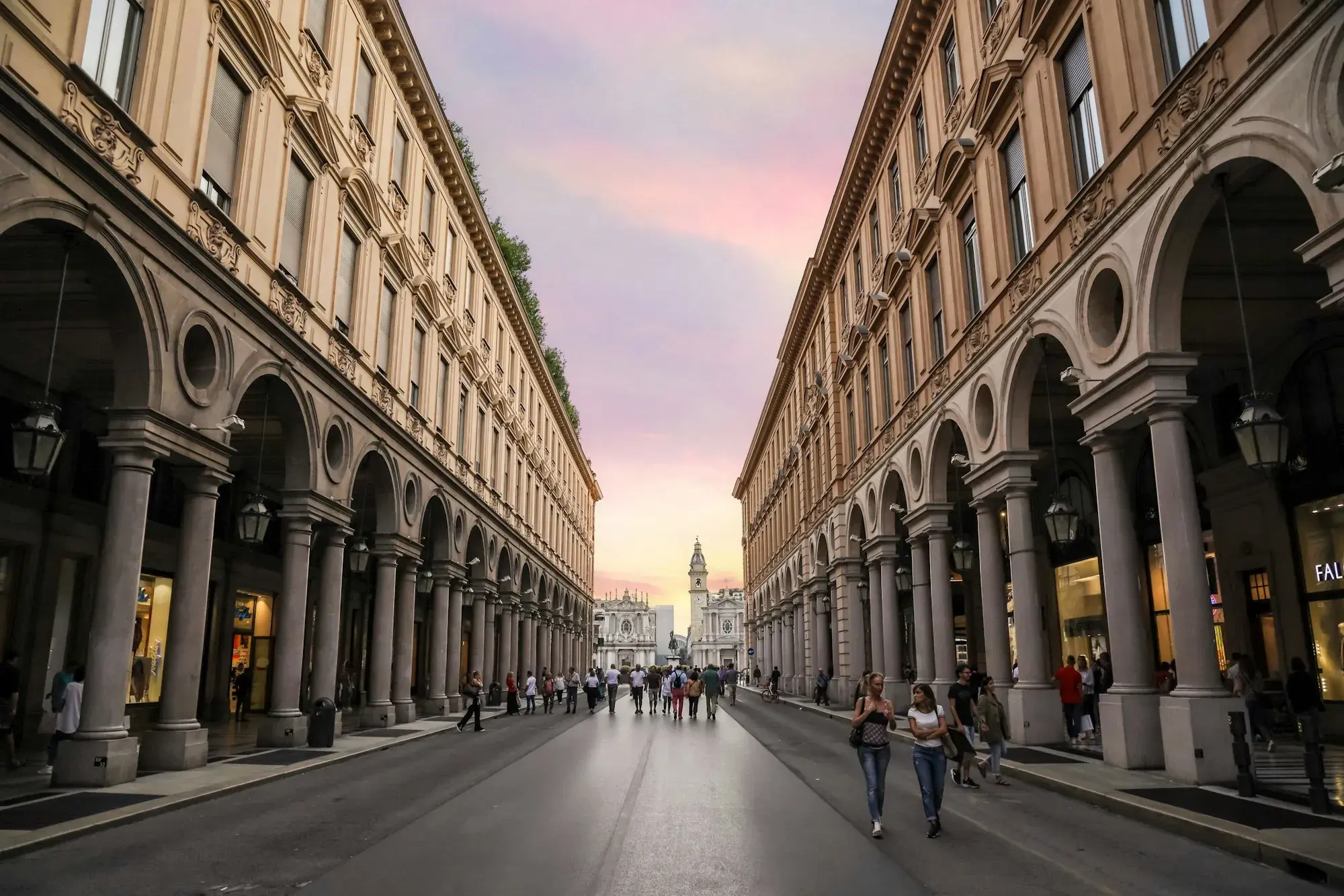 The arcades of Via Roma in Turin on both sides of the street, looking towards the churches of Piazza San Carlo at sunset