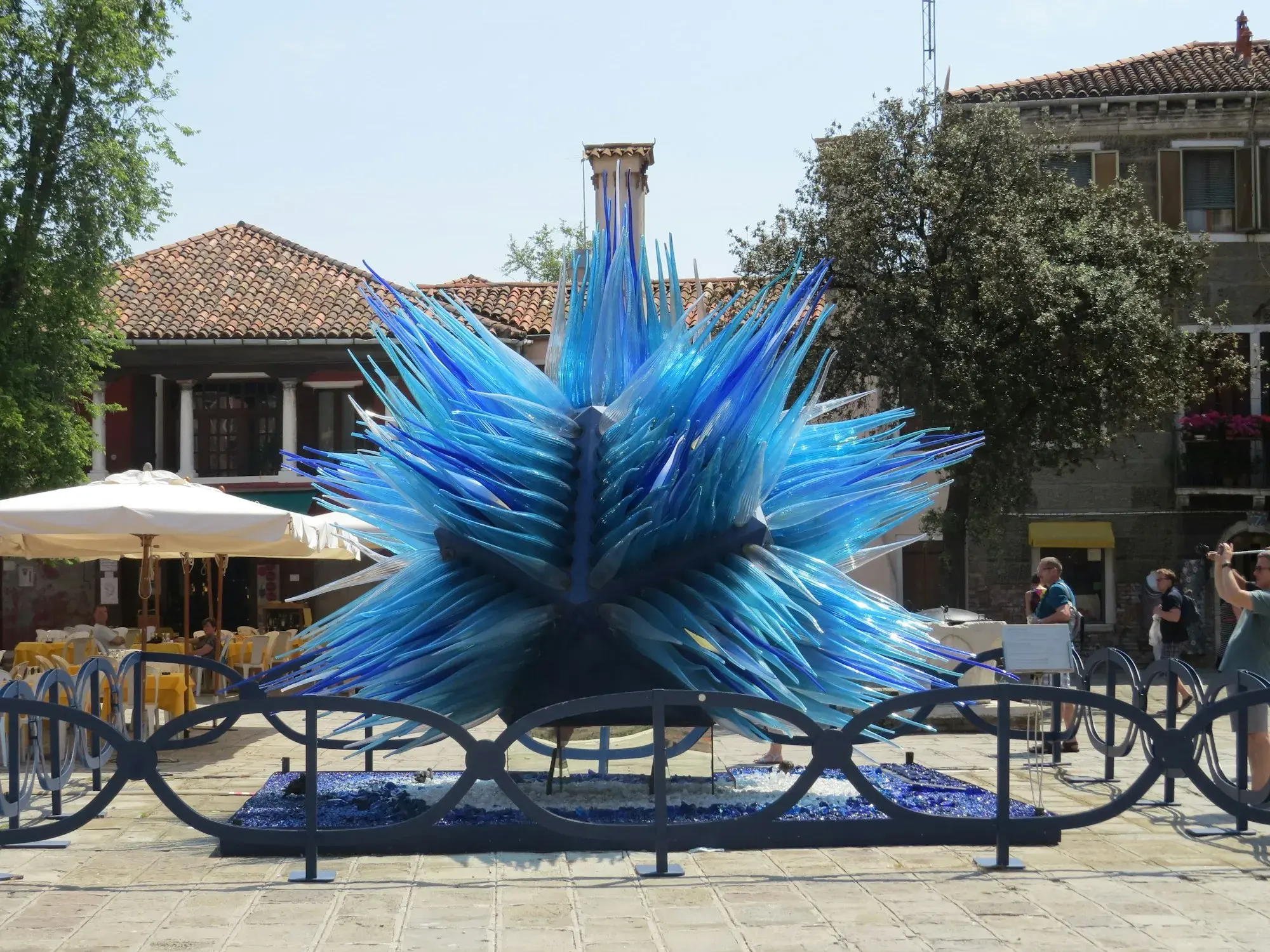The Comet Glass Star, a large blue glass sculpture of hundreds of glass needles, in a square on the island of Murano