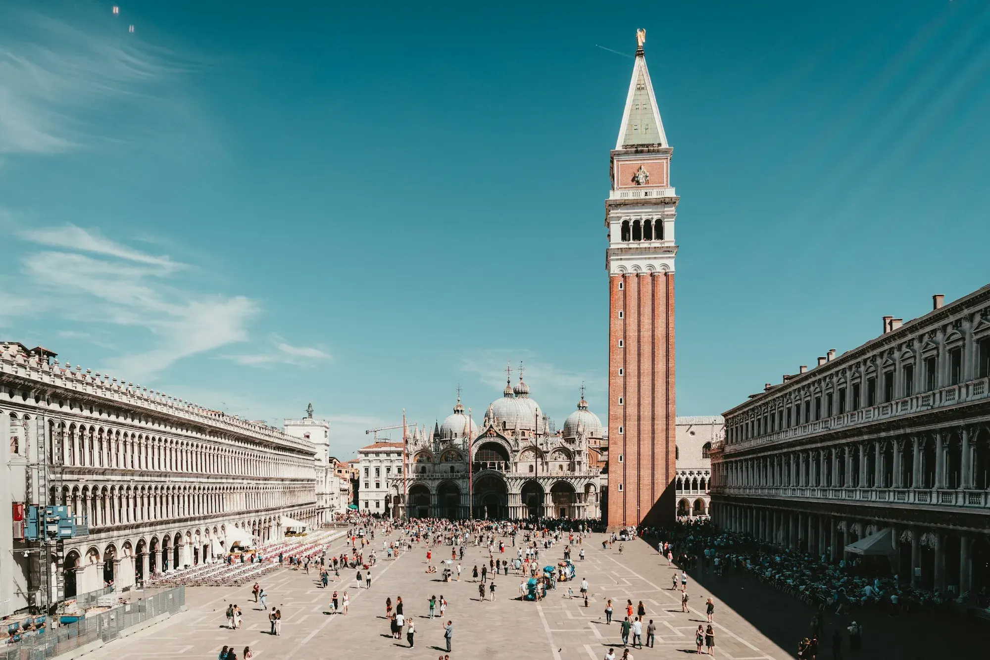 St Mark's Square in Venice with the brick Campanile, the domes of St Mark's Basilica and the arcaded Procuratie on either side