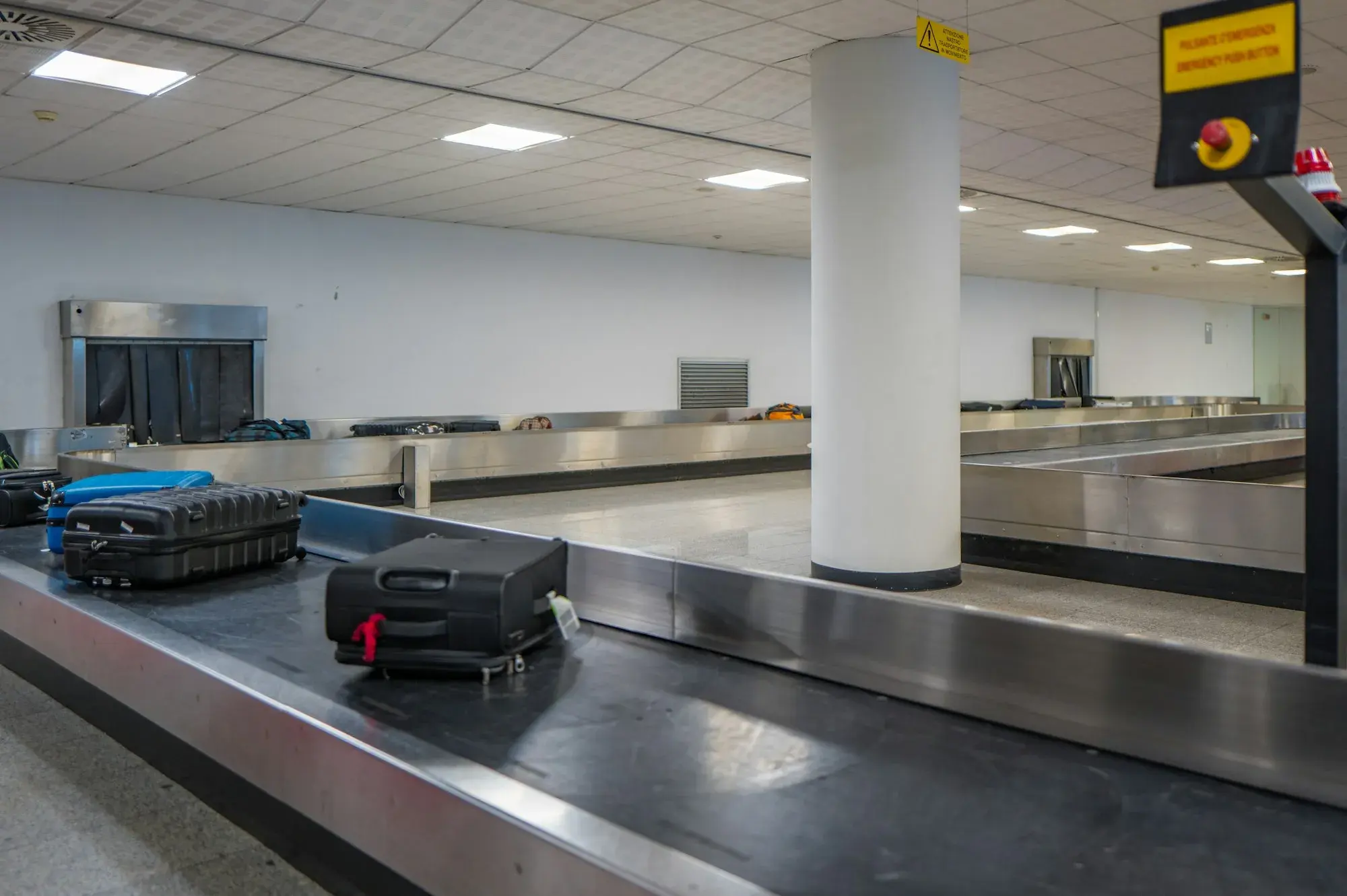Suitcases on a baggage reclaim belt in an airport arrivals hall