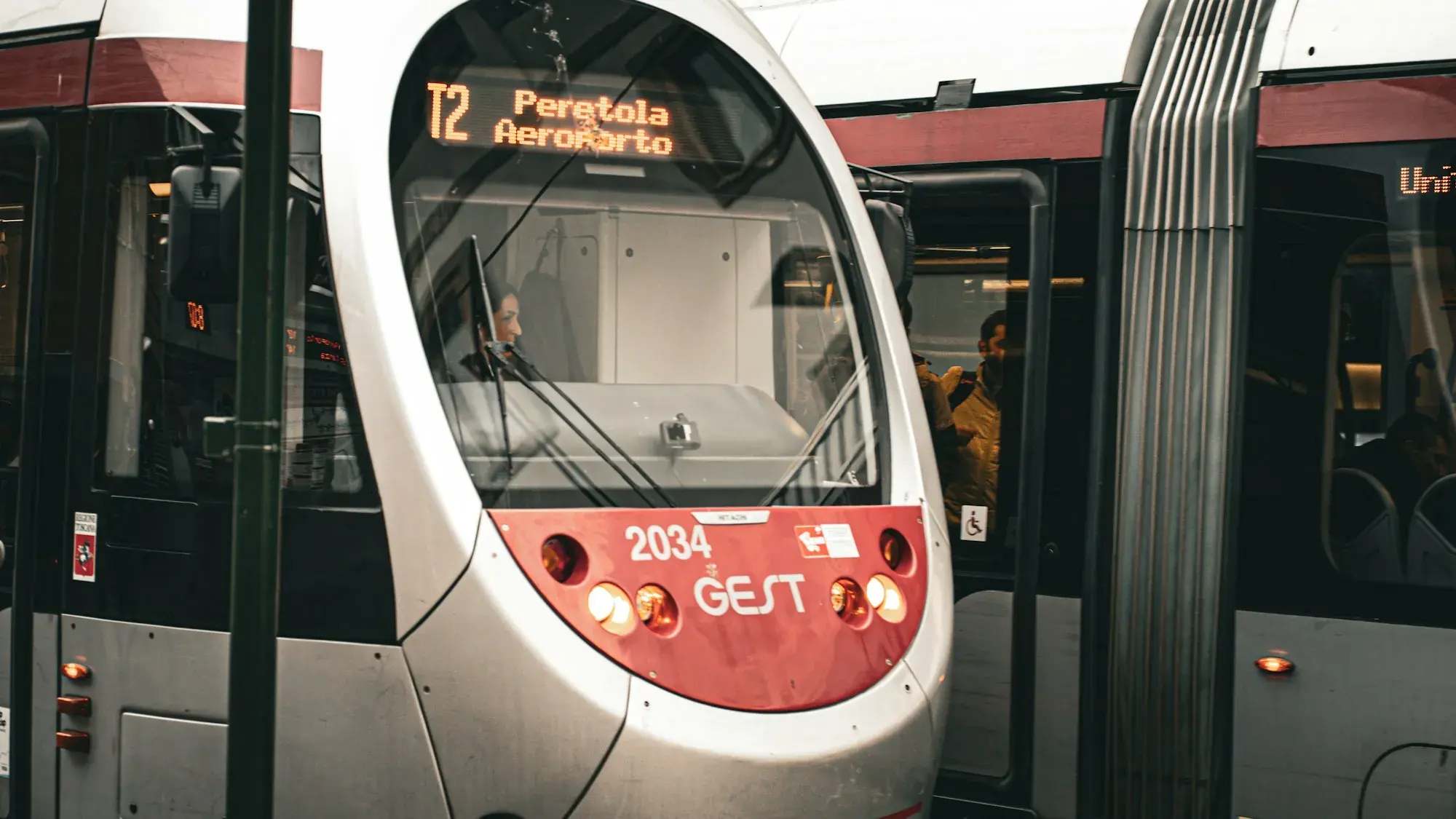 The front of a silver and red Florence tram showing T2 Peretola Aeroporto on its destination display