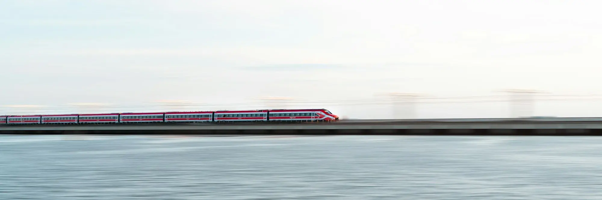 A Frecciarossa high-speed train crossing the causeway over the Venice lagoon