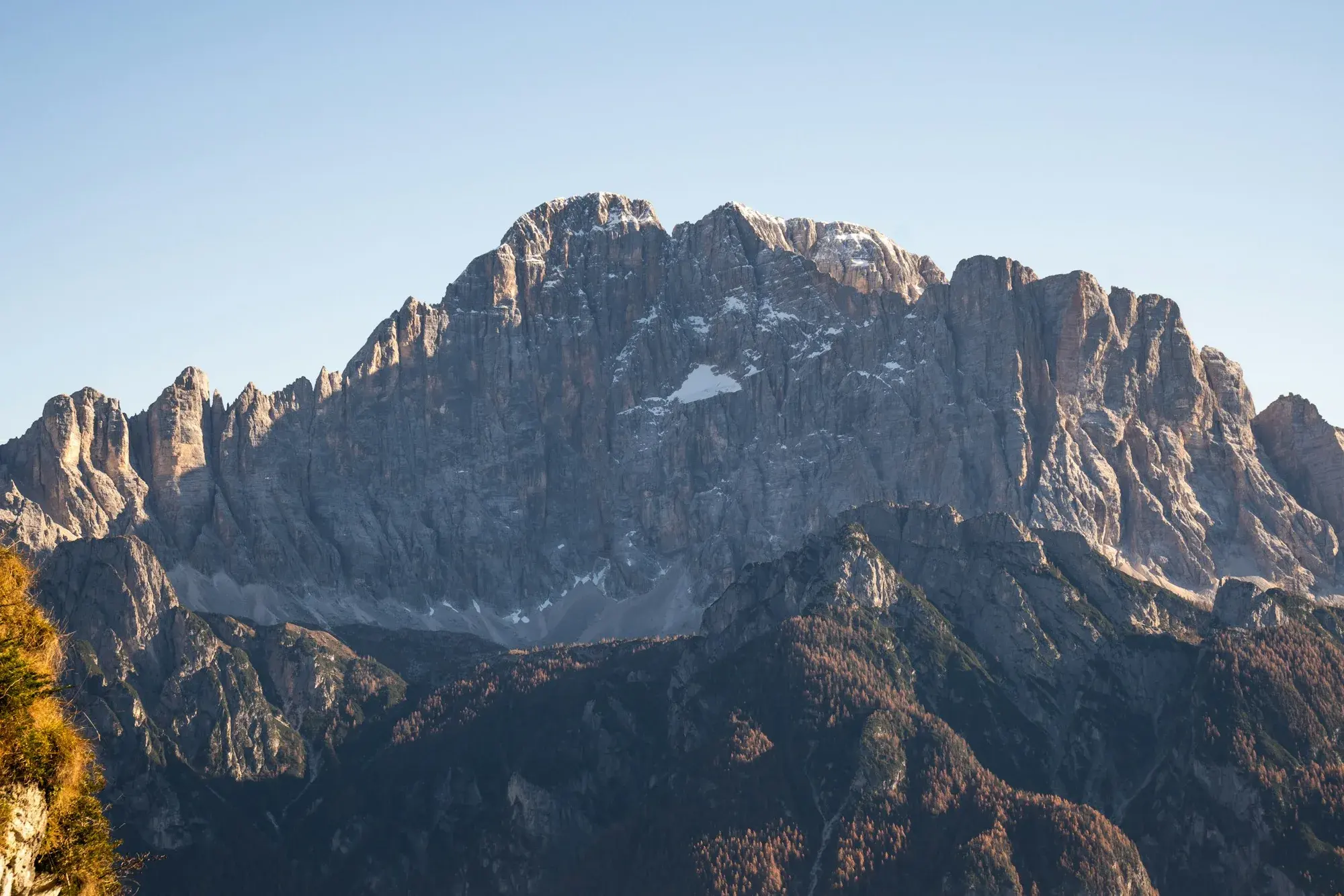 The Dolomite peaks rising above golden larch forests in full autumn colour in early November
