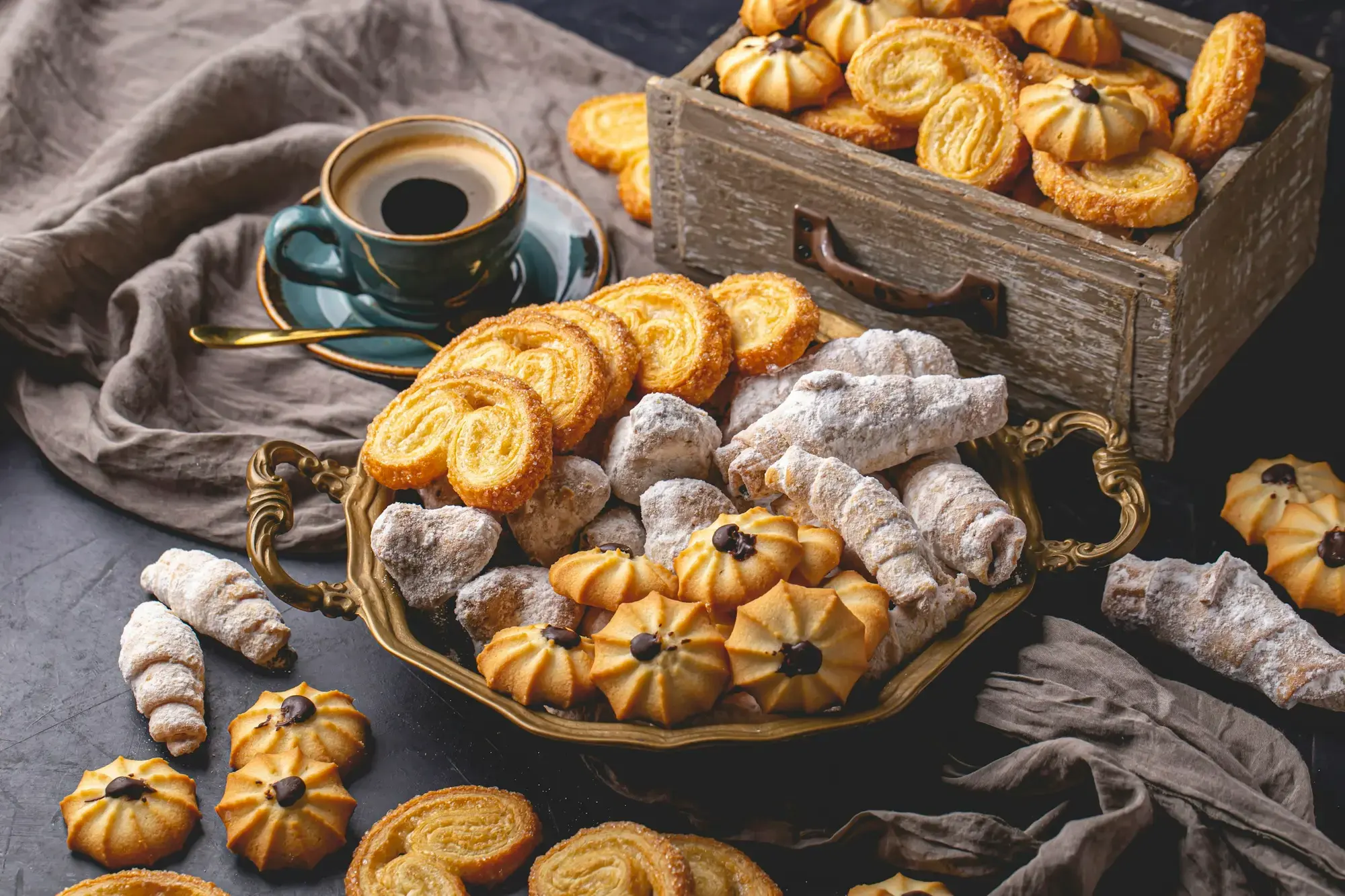 A basket of Italian biscuits beside a cup of coffee
