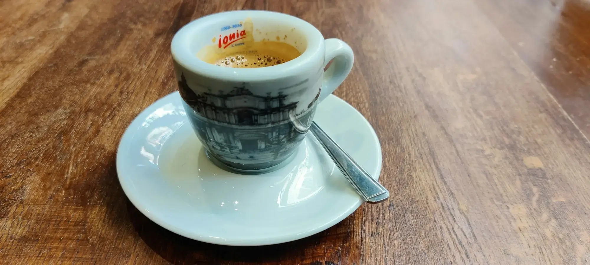 A cup of coffee on a saucer at an Italian bar counter in the morning