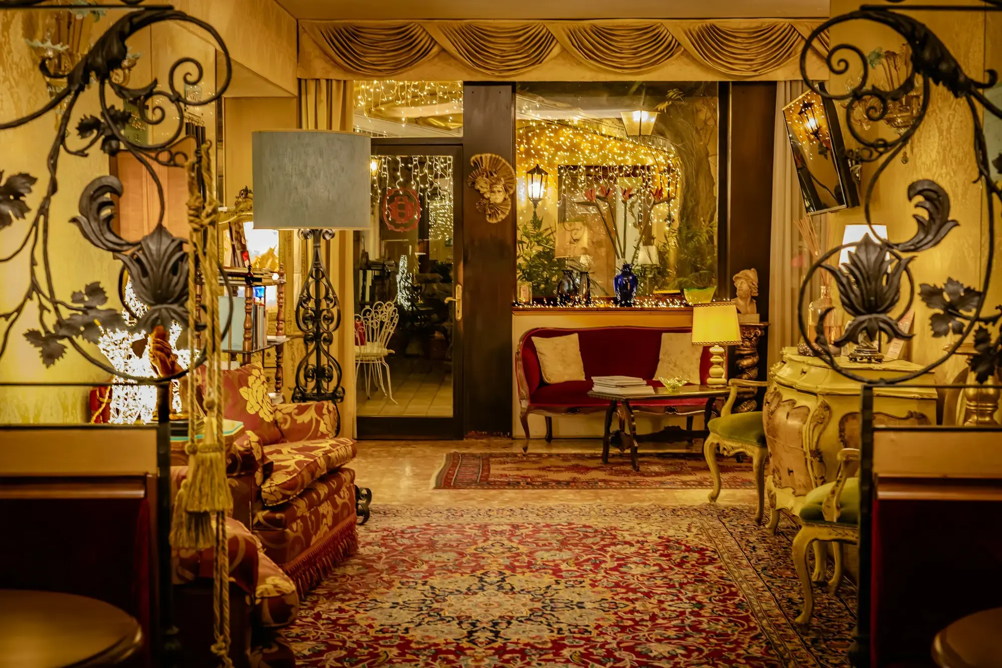 The ornate interior of a traditional Italian café with vintage décor and plush seating
