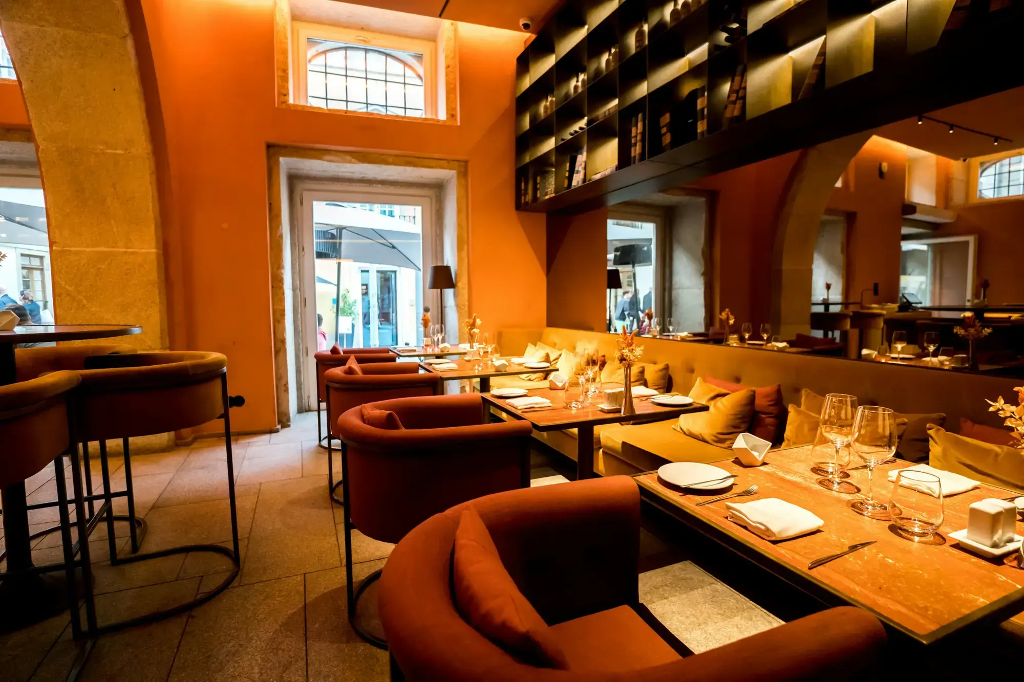 A cozy Italian restaurant interior with set tables and warm ambient lighting